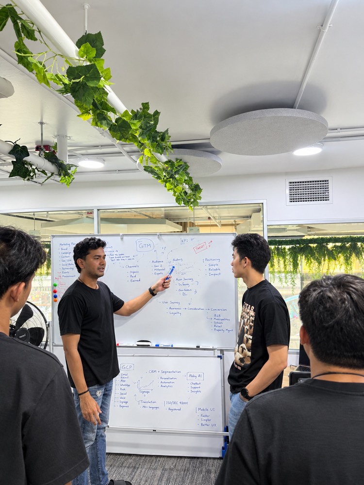 A teammate walking the team through a go-to-market plan on the whiteboard